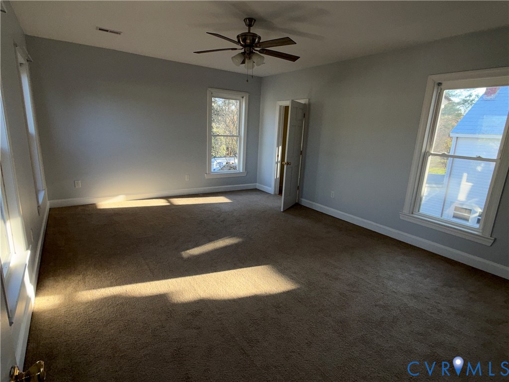 113 West Main Street Wakefield, VA 23888 - Photo 12 of 19 a view of a livingroom with a ceiling fan and window