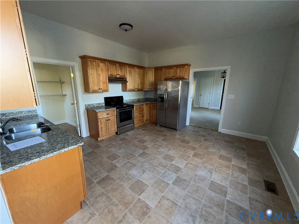 113 West Main Street Wakefield, VA 23888 - Photo 2 of 19 a kitchen with stainless steel appliances granite countertop a sink stove and refrigerator