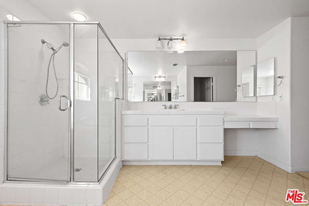 1061 Boulder Place Oceanside, CA 92057 - Photo 15 of 19 a bathroom with a double vanity sink mirror and shower