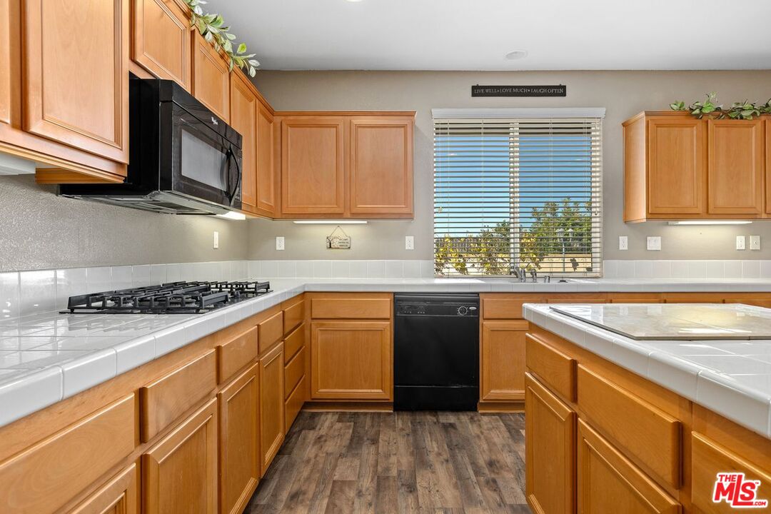 1061 Boulder Place Oceanside, CA 92057 - Photo 5 of 19 a kitchen with stainless steel appliances granite countertop a sink stove and microwave