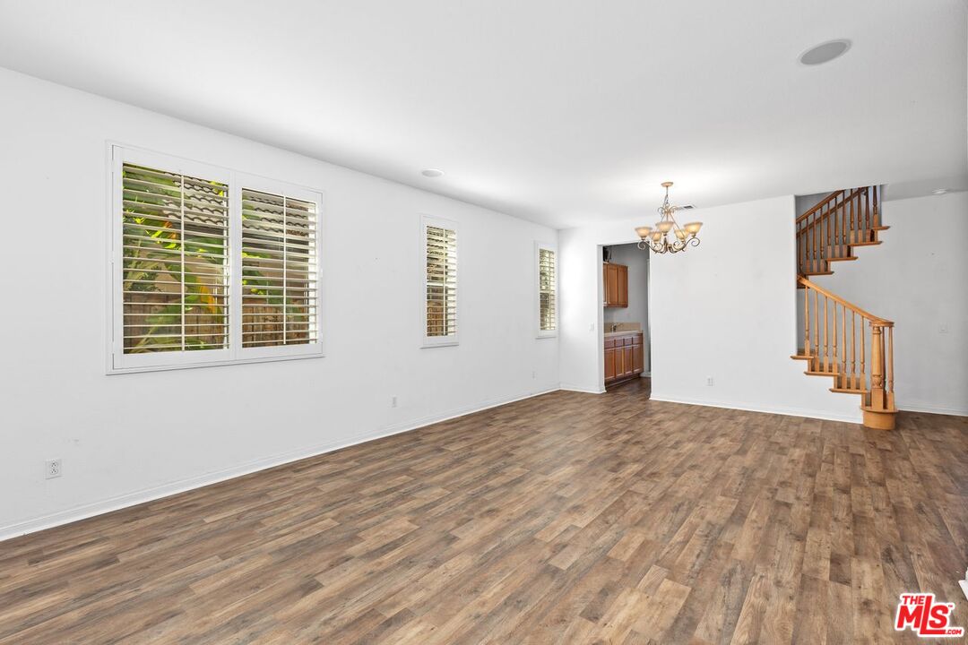 1061 Boulder Place Oceanside, CA 92057 - Photo 10 of 19 a view of empty room with wooden floor and fan