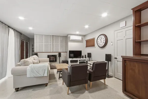 a living room with furniture a large window and a clock