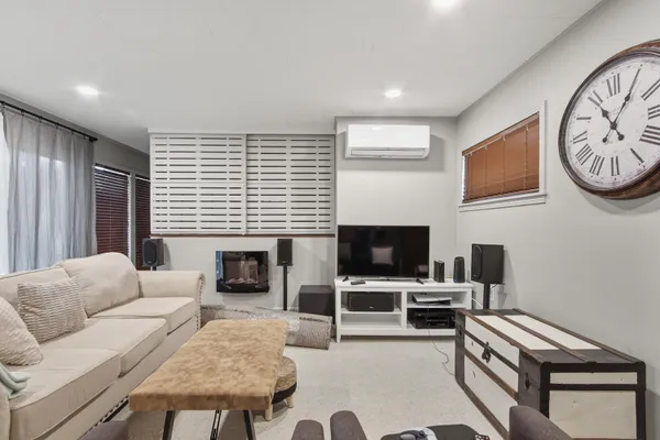 a living room with furniture a flat screen tv and a fireplace