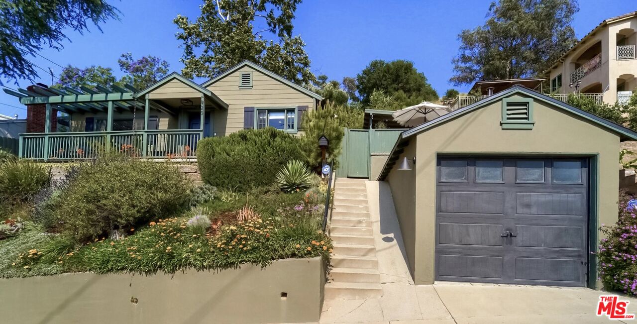 920 Highline Road Glendale, CA 91205 - Photo 2 of 49 a front view of a house with a yard and garage