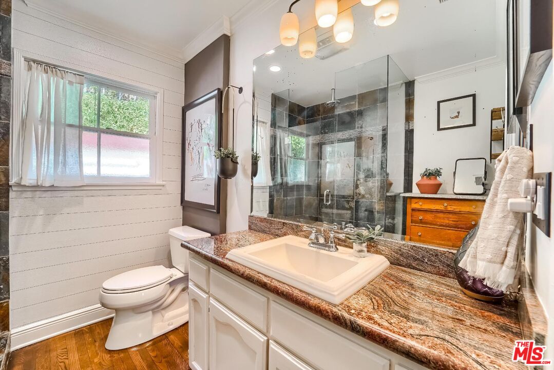 920 Highline Road Glendale, CA 91205 - Photo 36 of 49 a bathroom with a sink a toilet and a mirror
