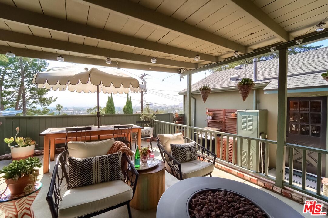 920 Highline Road Glendale, CA 91205 - Photo 41 of 49 a view of a roof deck with couches and wooden floor