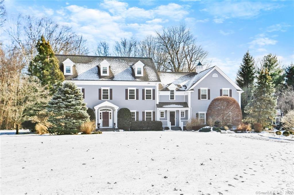 31 New Canaan Road Wilton, CT 06897 - Photo 1 of 1 a front view of a house with a yard covered in snow