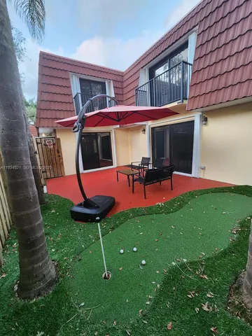 a backyard of a house with table and chairs