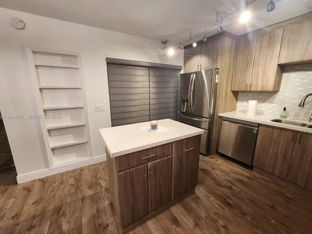 a kitchen with a sink stove and refrigerator