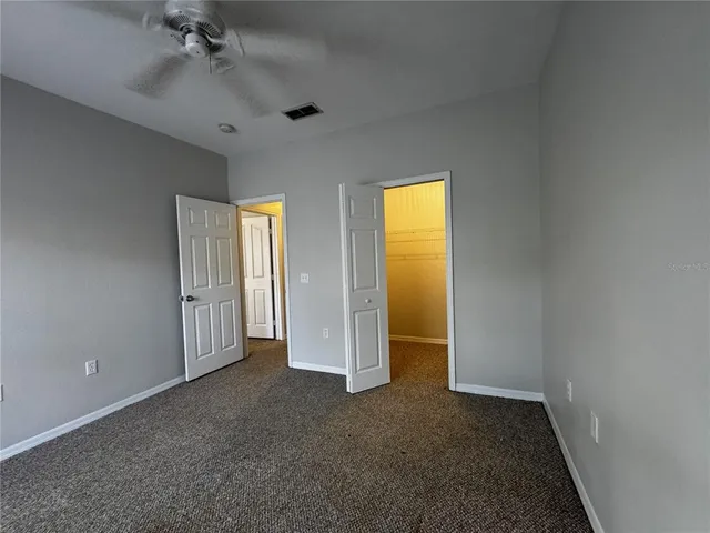 an empty room with a window and fire place