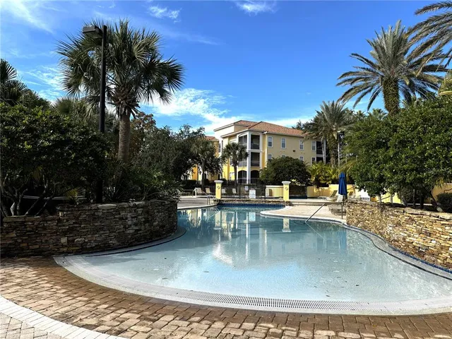 a view of a swimming pool with outdoor seating