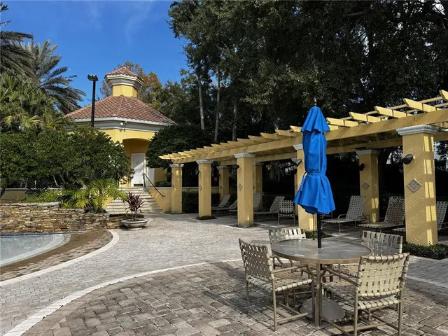 a view of a chair and tables in the patio
