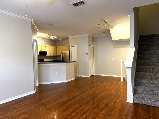 a view of a kitchen cabinets and a wooden floor