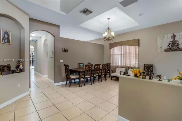a dining room with furniture and window