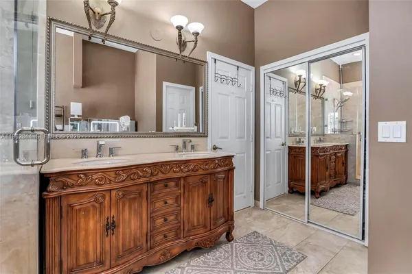 a spacious bathroom with a granite countertop sink mirror and
