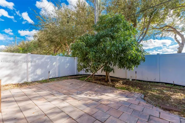 a view of a backyard with a tree