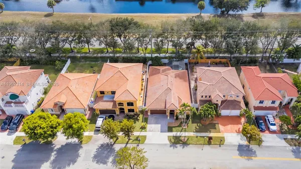 an aerial view of houses with a lake
