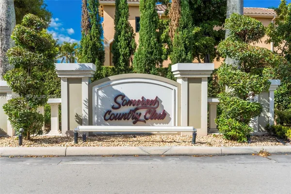 a view of a brick house with a tree in front of it