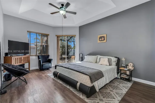 a bedroom with a bed window and a flat screen tv