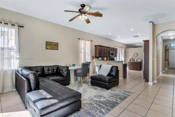 a living room with furniture and kitchen view