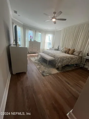 a spacious bedroom with a bed and a chandelier