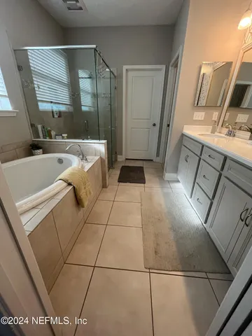 a bathroom with a bathtub and a sink