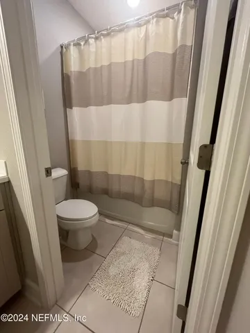 a bathroom with a shower and a toilet