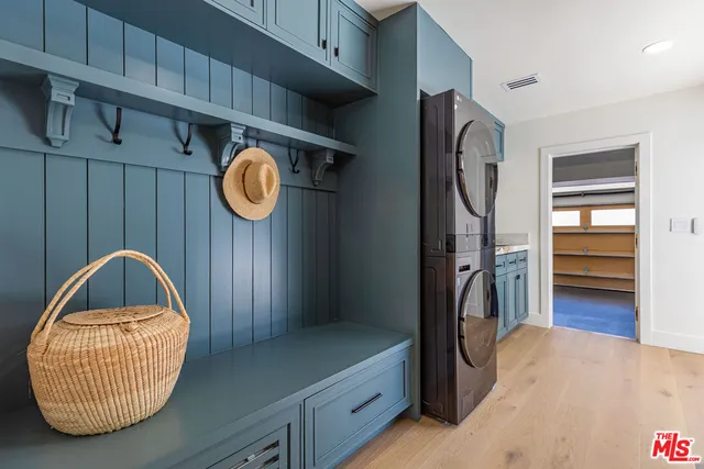 a view of an empty room with windows & cabinet