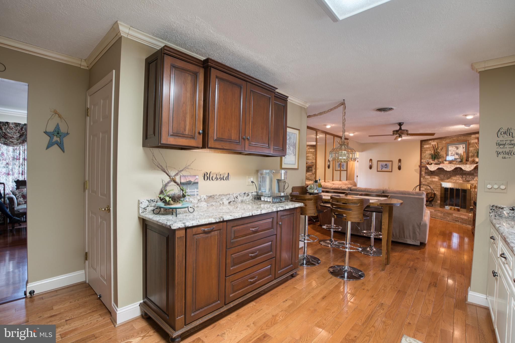 2026 Fallsgrove Way Fallston, MD 21047 - Photo 26 of 62 a kitchen with stainless steel appliances granite countertop a table chairs and a refrigerator