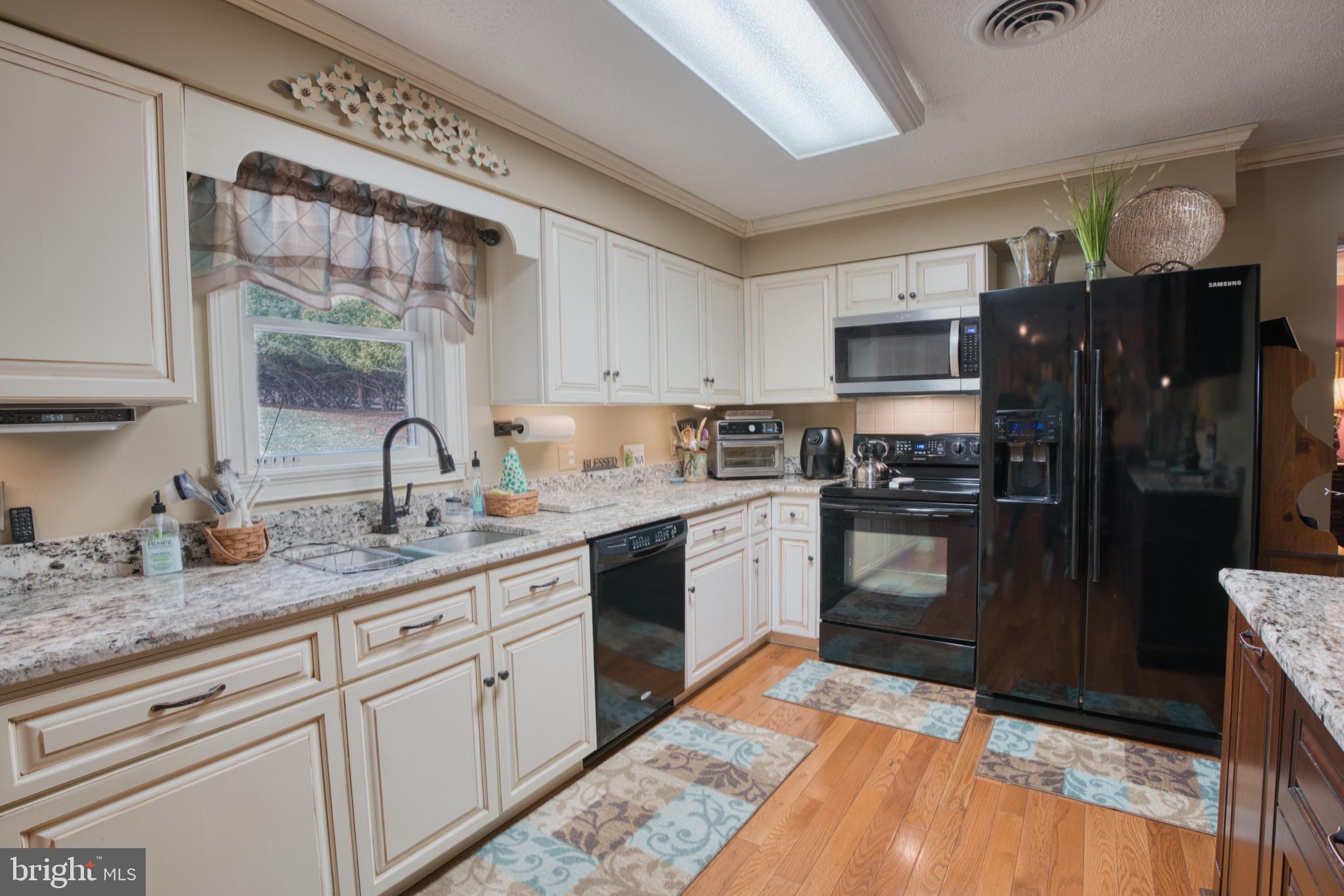 2026 Fallsgrove Way Fallston, MD 21047 - Photo 28 of 62 a kitchen with stainless steel appliances granite countertop a refrigerator sink and cabinets
