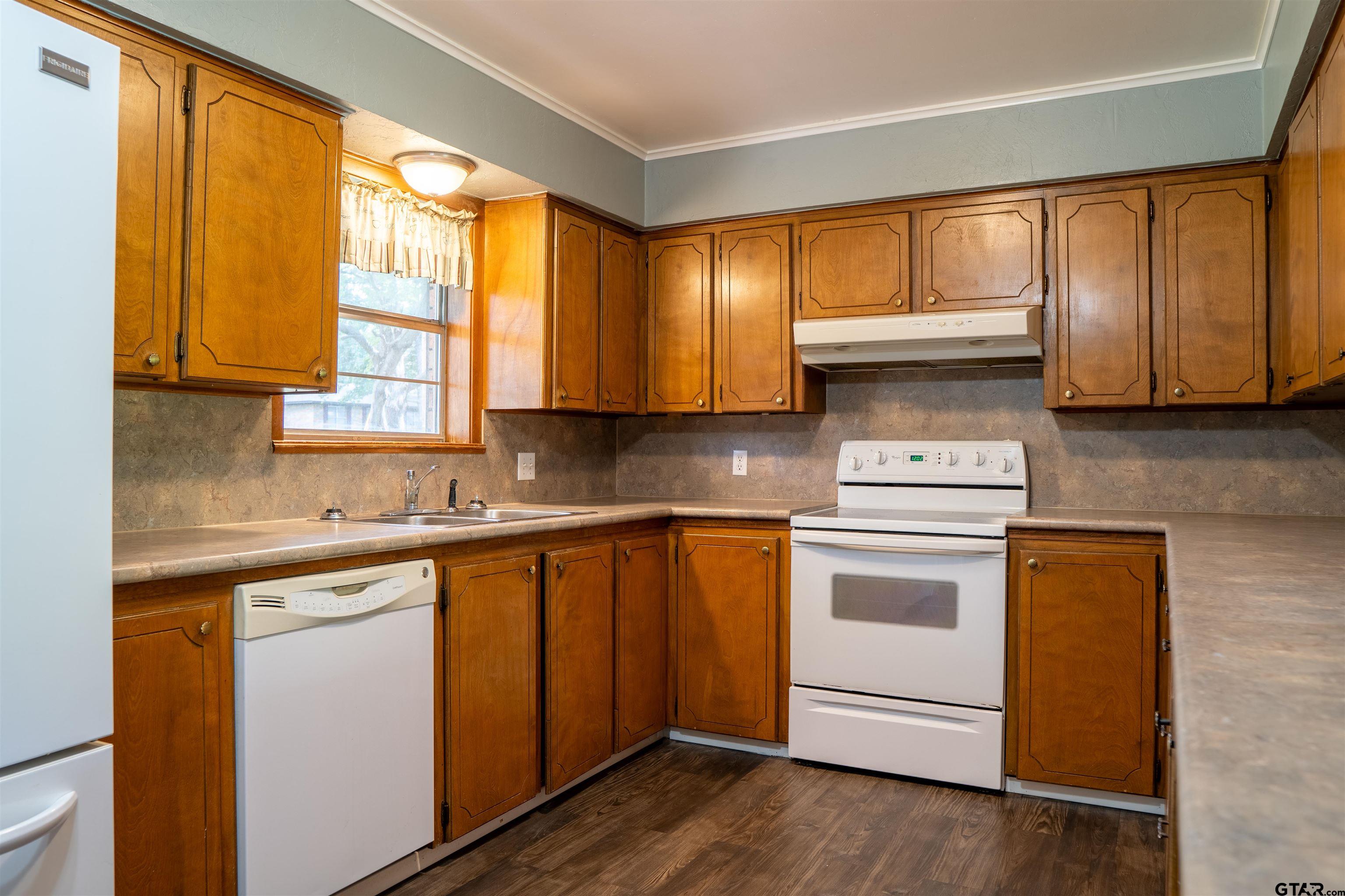 4006 Mark Lane Mount Pleasant, TX 75455 - Photo 13 of 28 a kitchen with a stove a sink and a microwave