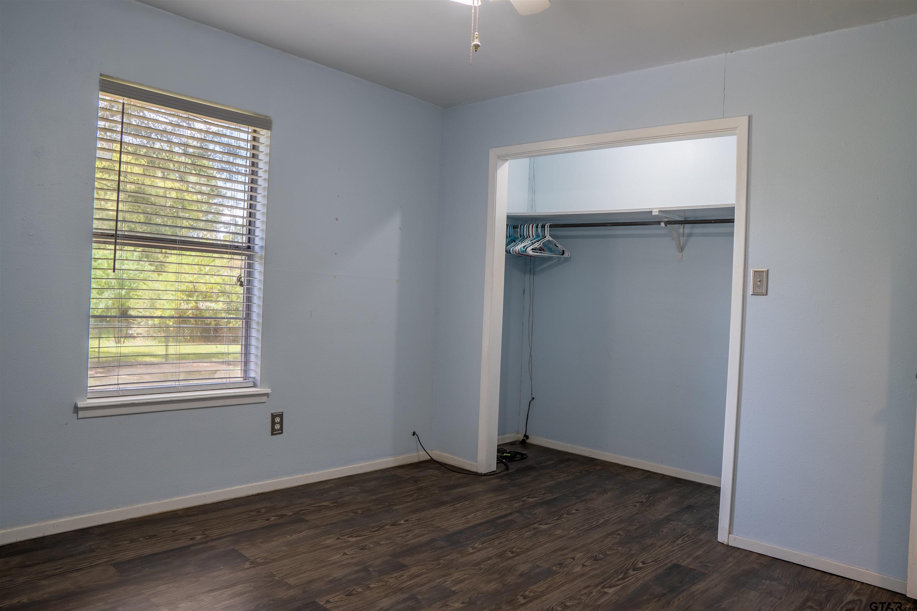 4006 Mark Lane Mount Pleasant, TX 75455 - Photo 16 of 28 a view of an empty room with wooden floor and a window