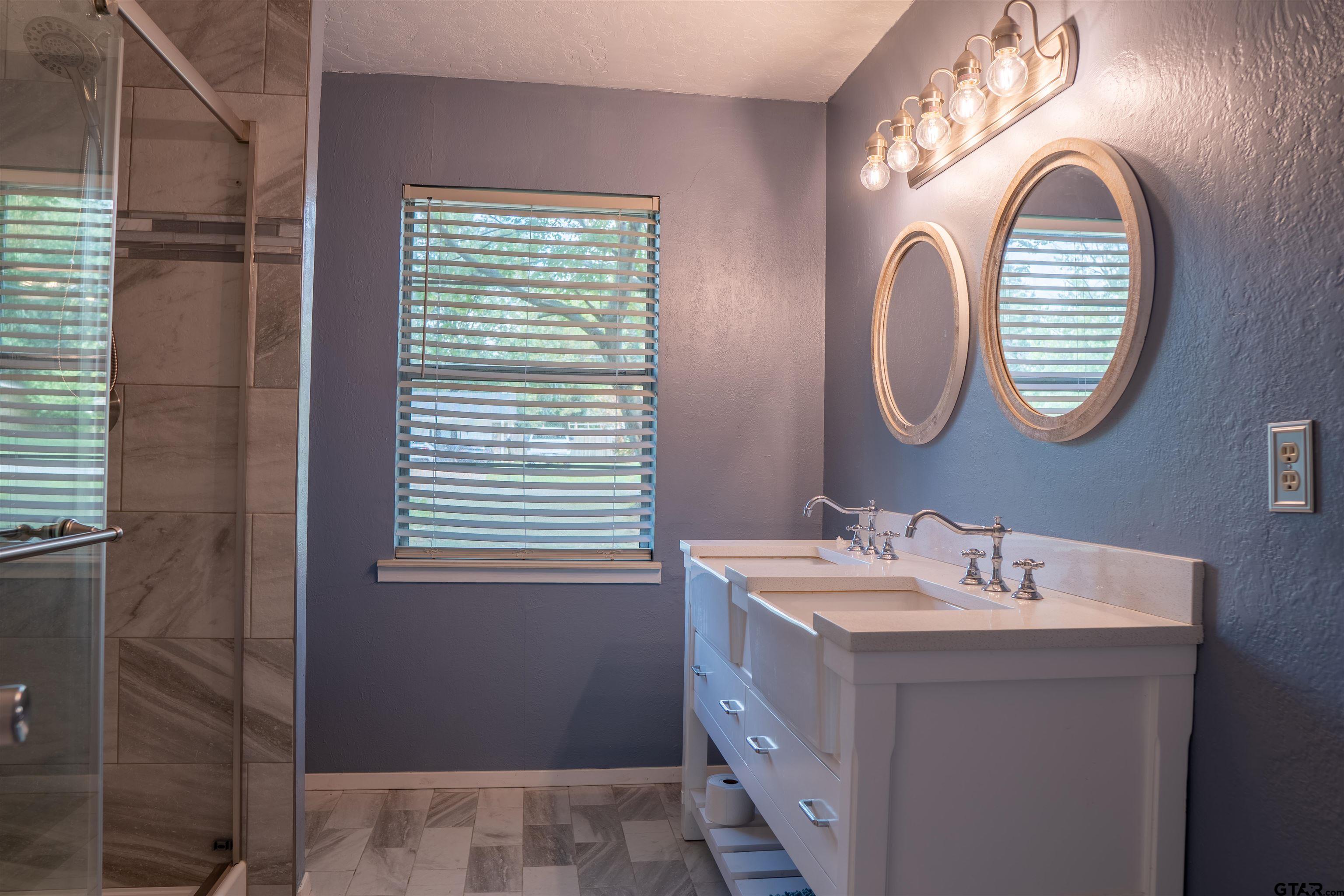 4006 Mark Lane Mount Pleasant, TX 75455 - Photo 21 of 28 a bathroom with a sink and a mirror