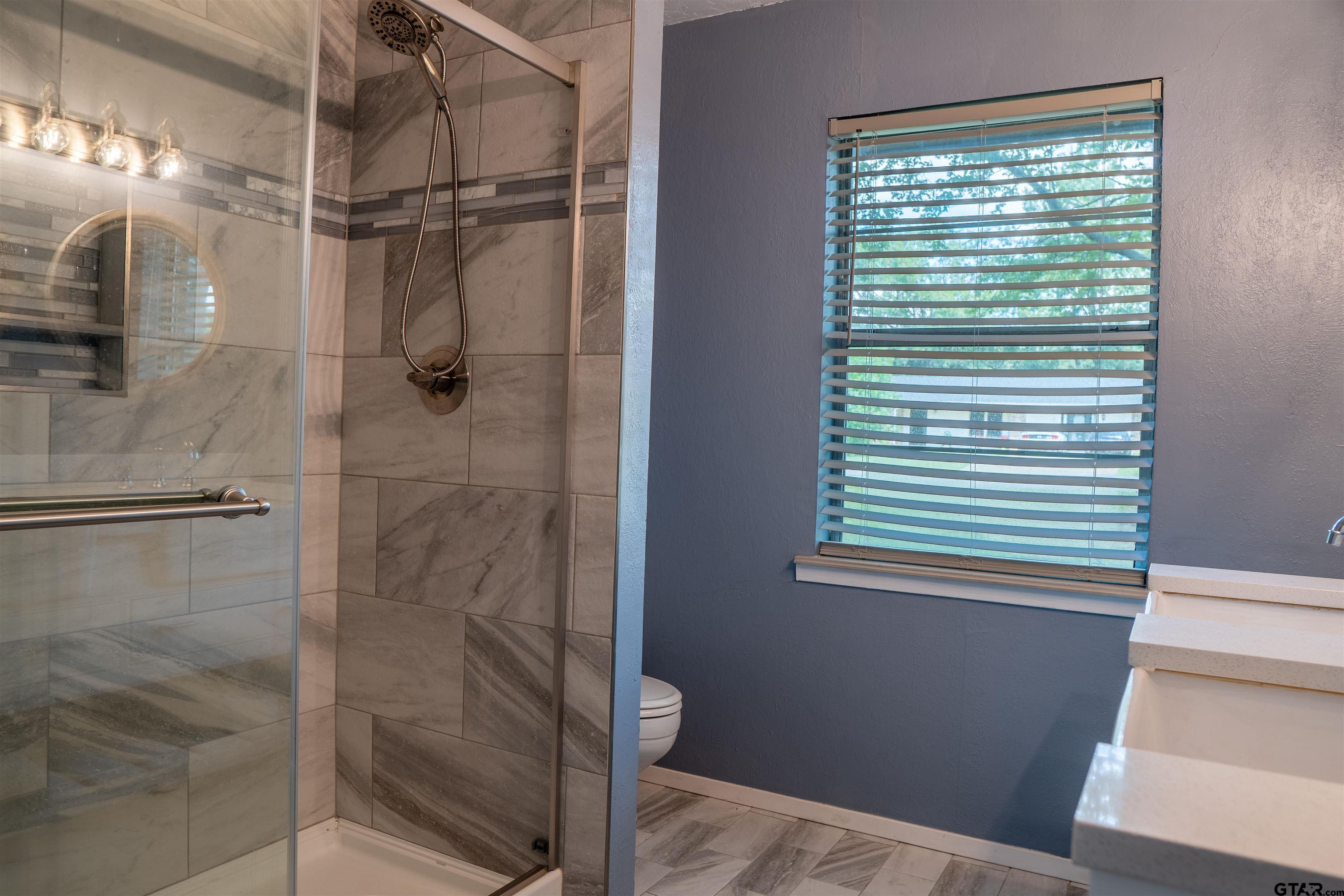 4006 Mark Lane Mount Pleasant, TX 75455 - Photo 22 of 28 a bathroom with a shower and a window