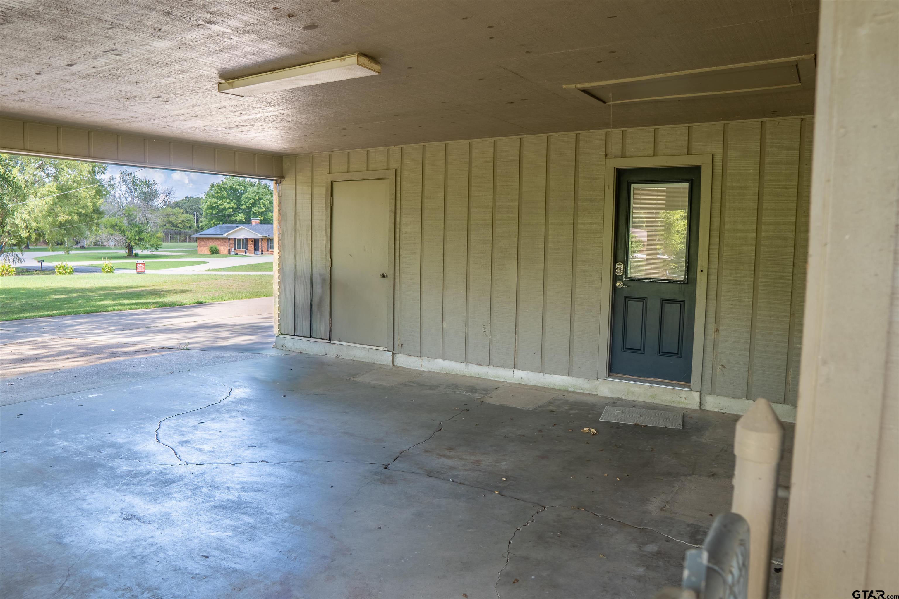 4006 Mark Lane Mount Pleasant, TX 75455 - Photo 28 of 28 an empty room with large windows and a yard