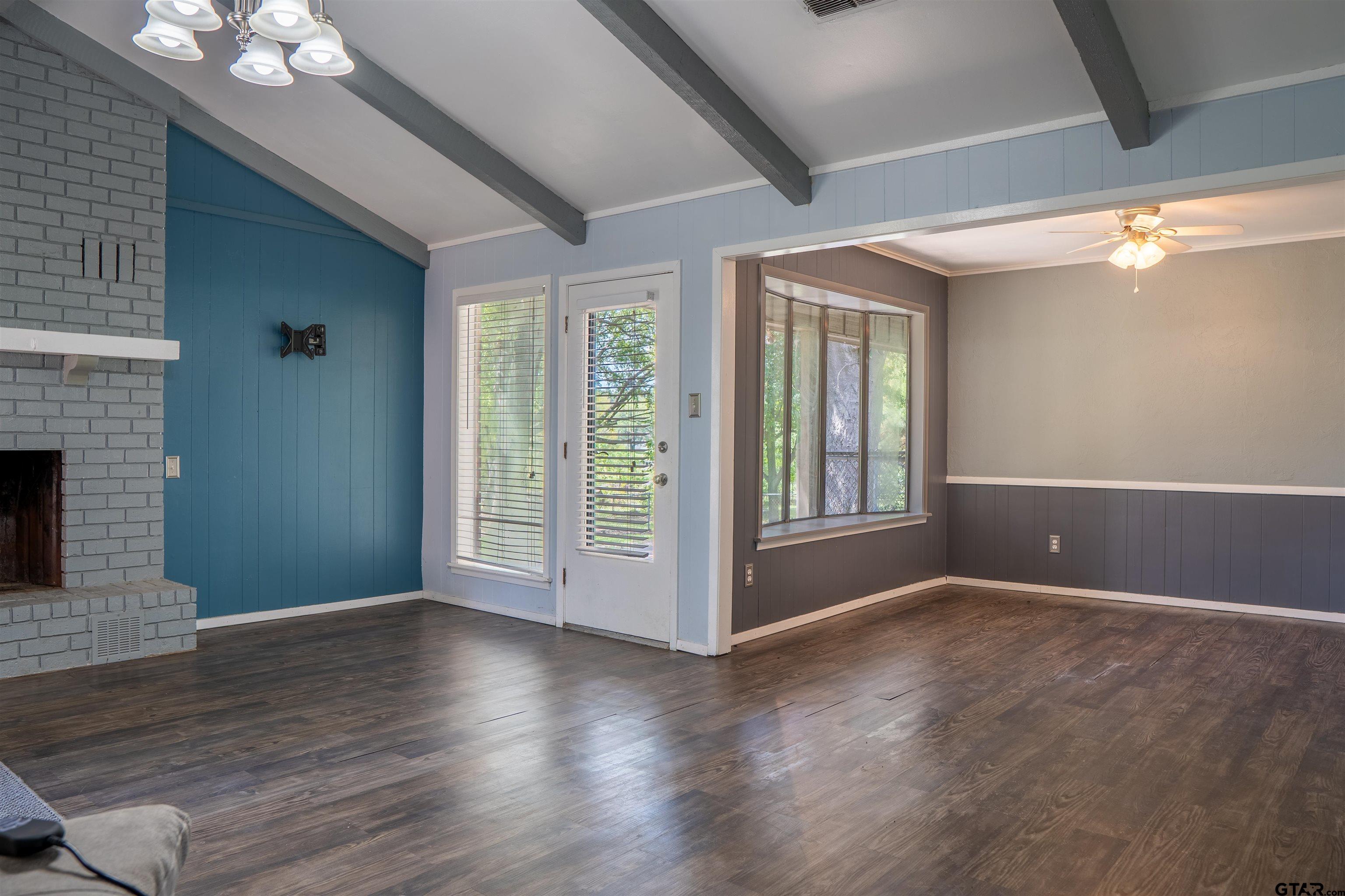 4006 Mark Lane Mount Pleasant, TX 75455 - Photo 7 of 28 an empty room with wooden floor and windows