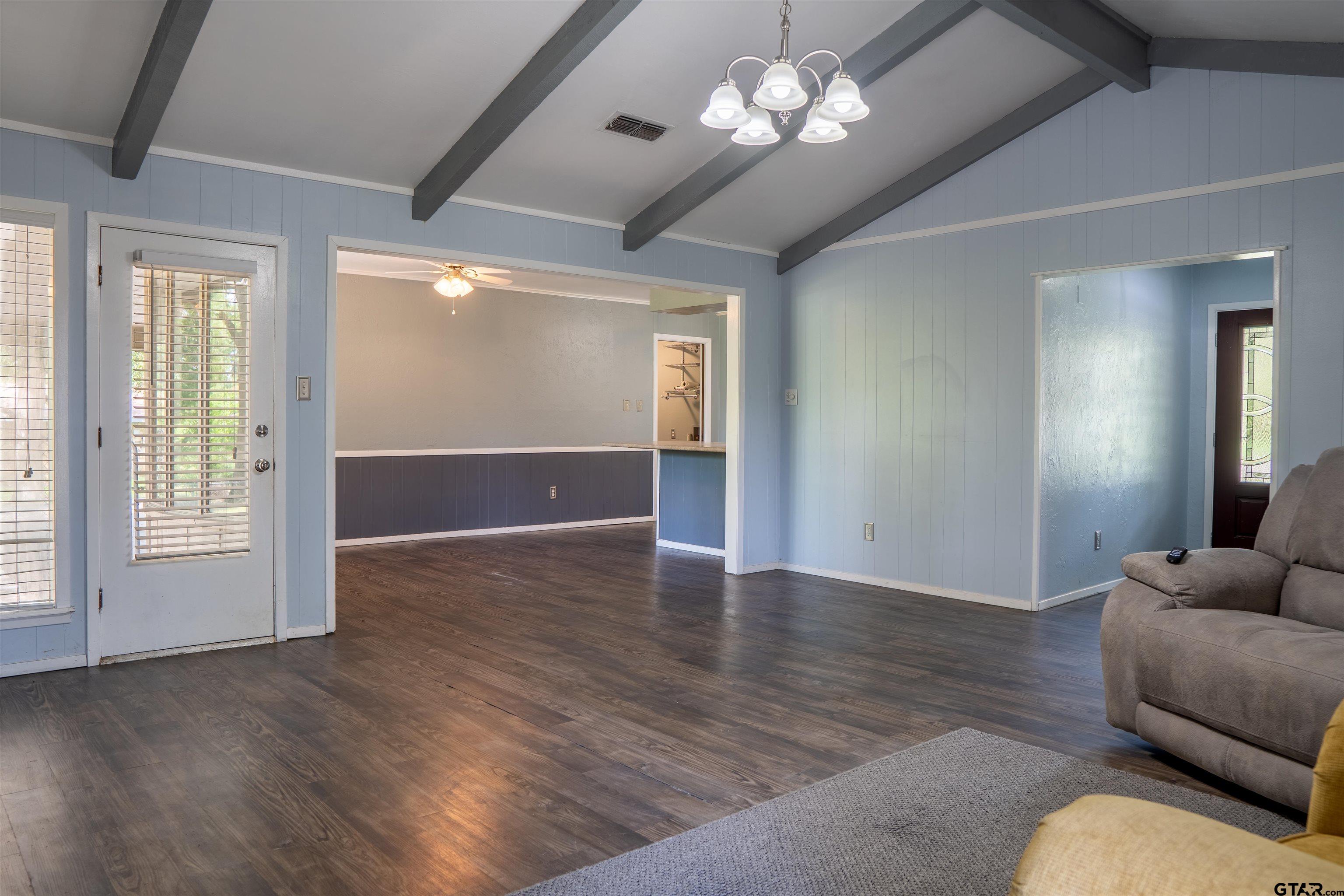 4006 Mark Lane Mount Pleasant, TX 75455 - Photo 8 of 28 a view of livingroom with furniture chandelier fan and wooden floor