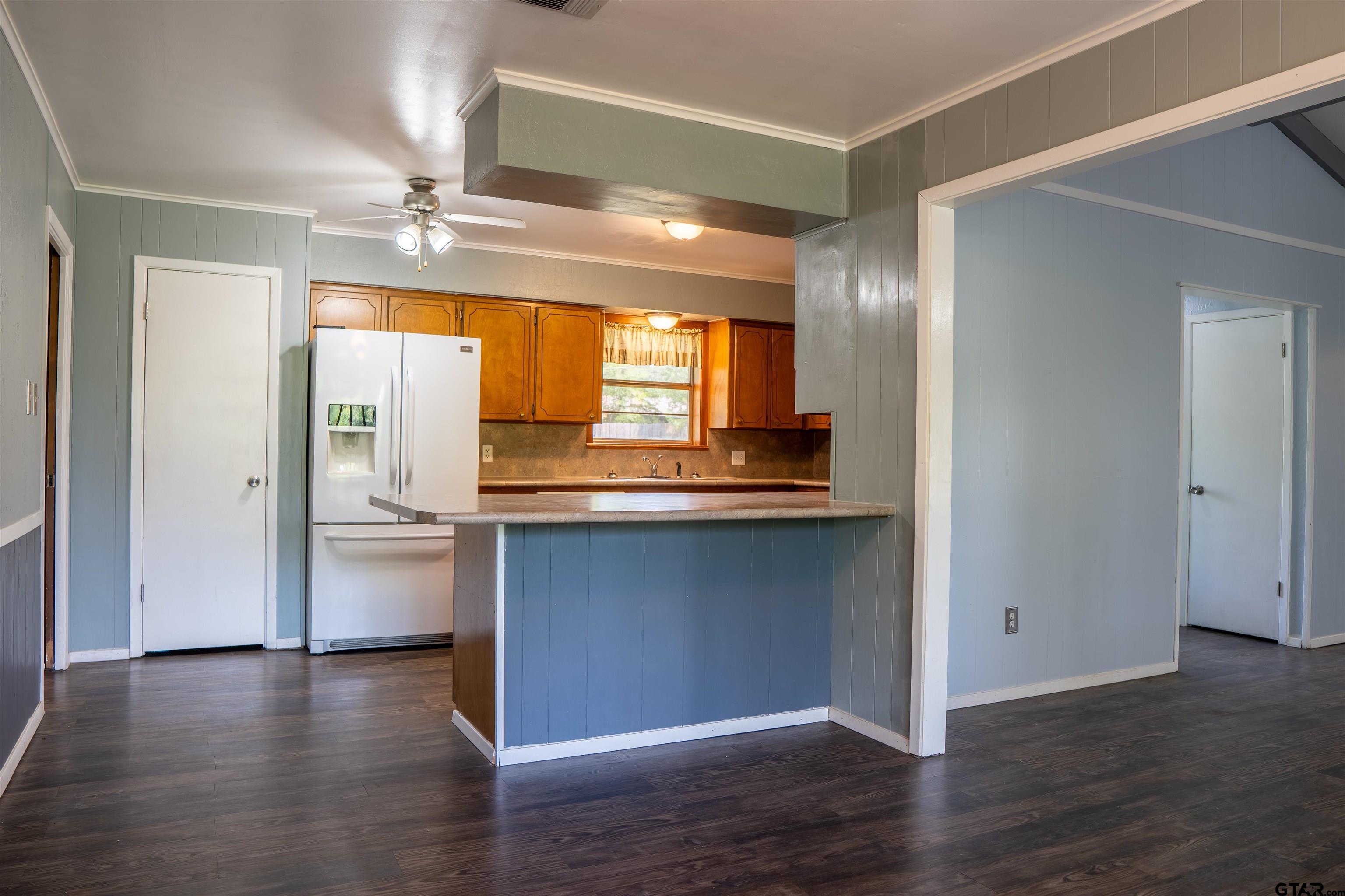 4006 Mark Lane Mount Pleasant, TX 75455 - Photo 10 of 28 a kitchen with a refrigerator and countertop