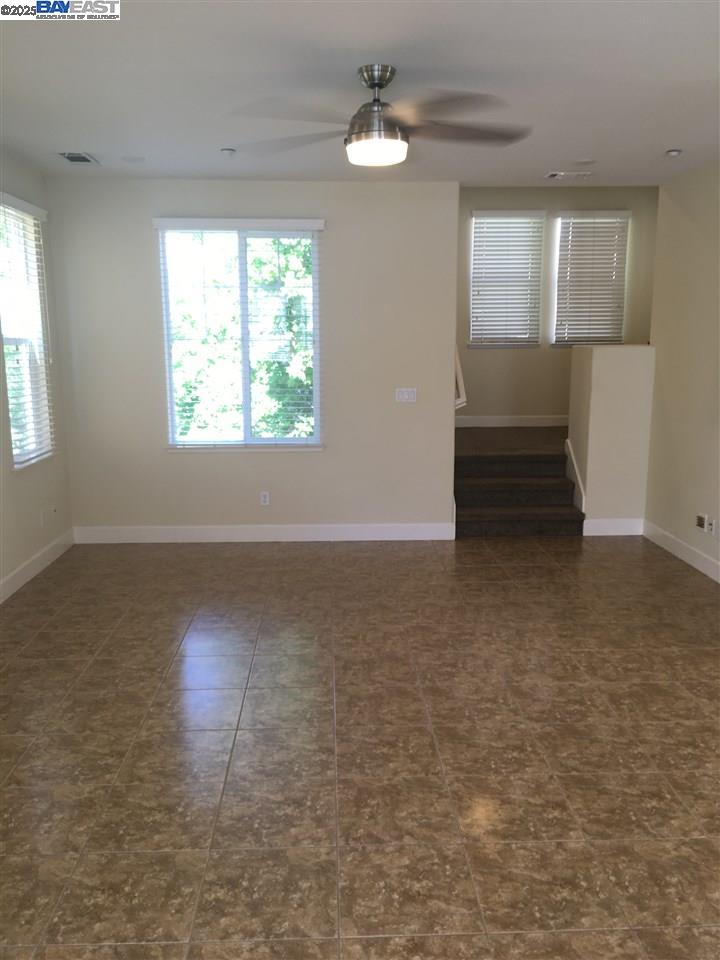 2846 Mint Common Livermore, CA 94551 - Photo 5 of 17 an empty room with chandelier fan and windows