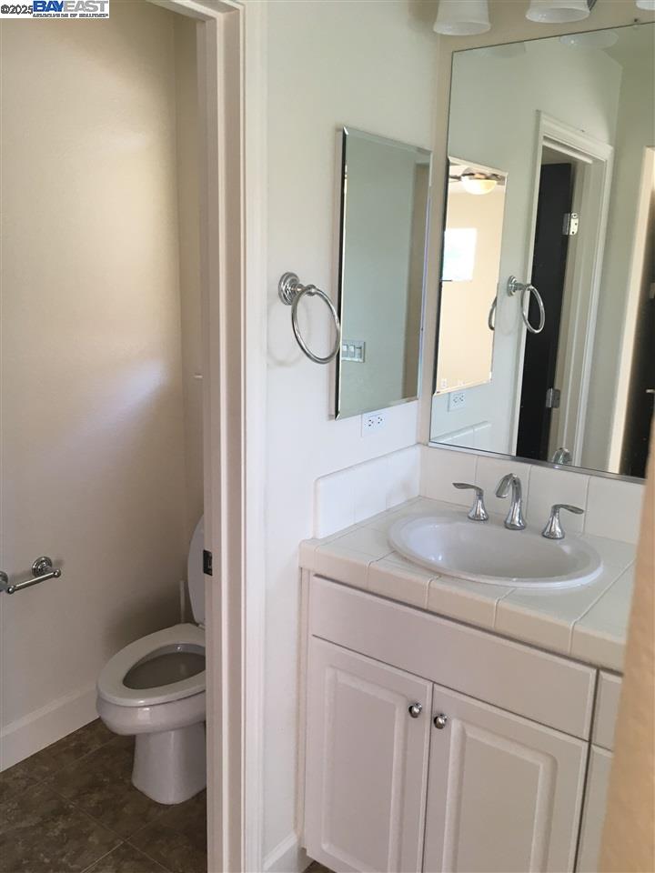 2846 Mint Common Livermore, CA 94551 - Photo 9 of 17 a bathroom with a granite countertop toilet sink and mirror