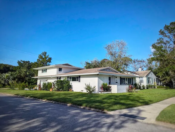 a front view of a house with a garden