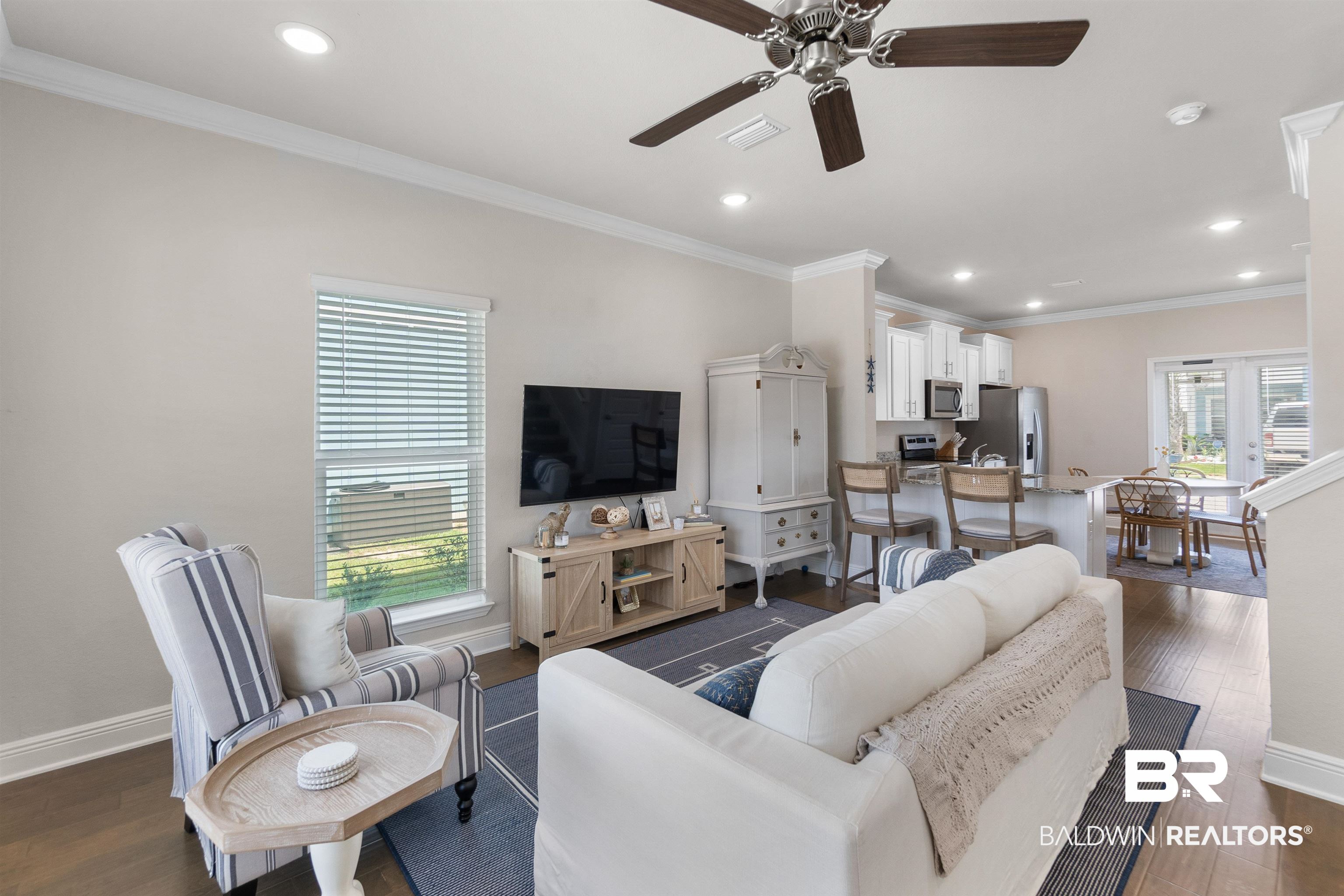 23975 Cottage Loop Orange Beach, AL 36561 - Photo 2 of 23 Living room with plenty of natural light, ceiling fan, dark hardwood / wood-style floors, and crown molding
