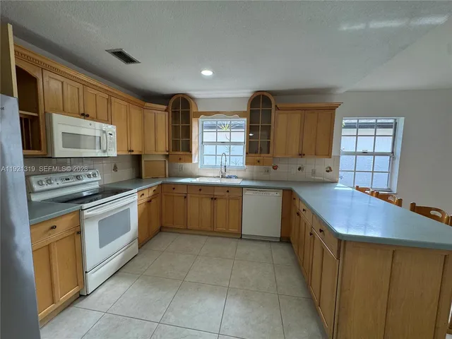 a room with table chairs and entryway