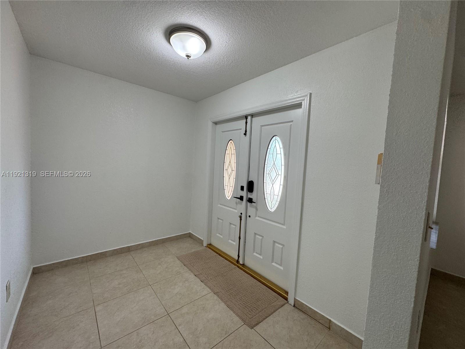 5332 Southwest 142nd Place Miami, FL 33175 - Photo 6 of 30 an empty room with mirror