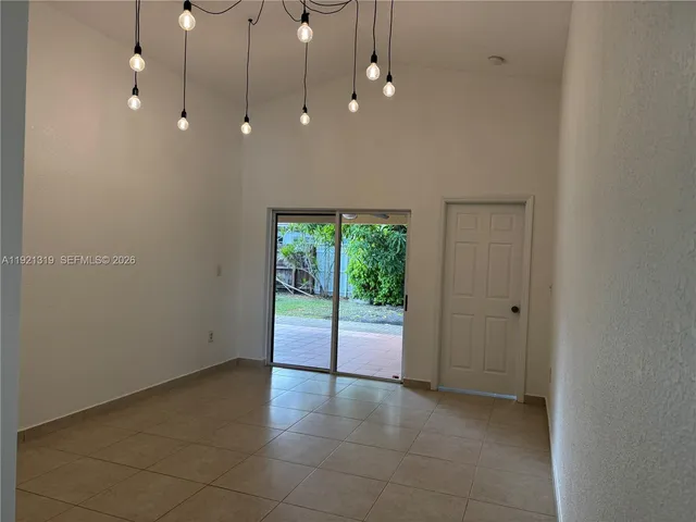 a view of a livingroom with a ceiling fan and window