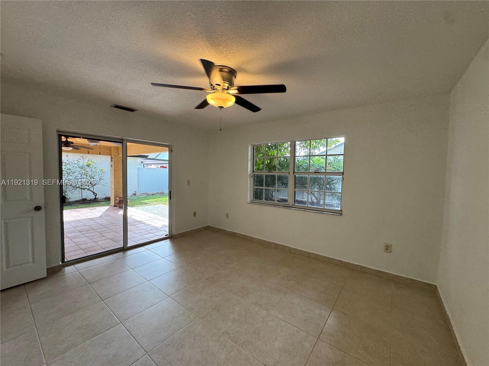 5332 Southwest 142nd Place Miami, FL 33175 - Photo 10 of 30 a view of a livingroom with a ceiling fan and window