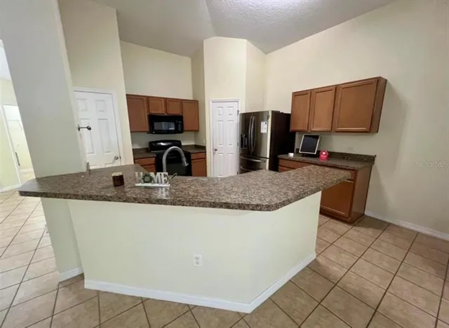 a kitchen with stainless steel appliances granite countertop a sink and a microwave