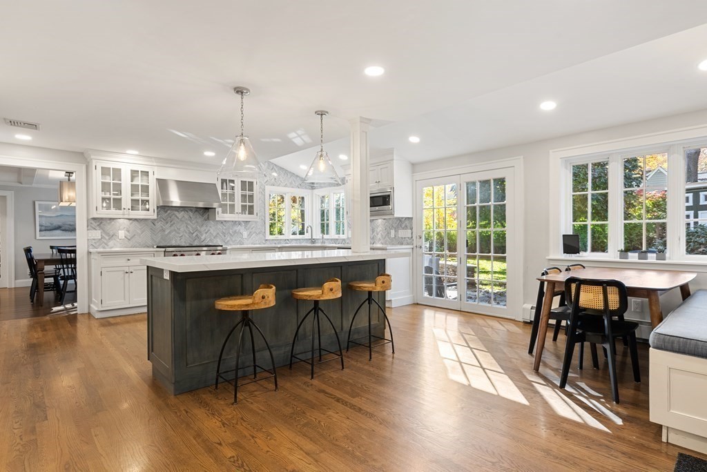33 Damien Road Wellesley, MA 02481 - Photo 16 of 41 a dining hall with stainless steel appliances granite countertop a stove a sink a dining table and chairs with wooden floor