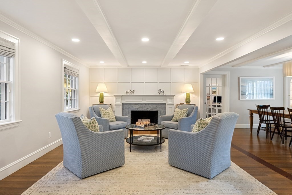 33 Damien Road Wellesley, MA 02481 - Photo 6 of 41 a living room with furniture a fireplace and a dining table with wooden floor