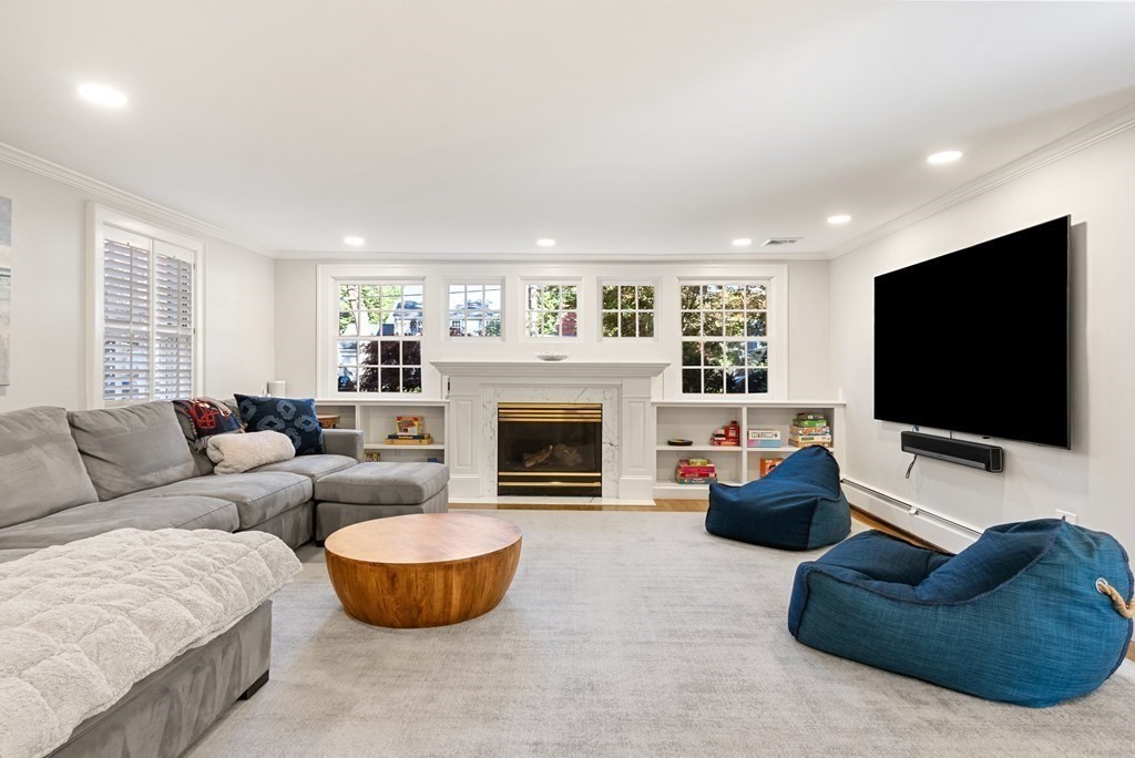 33 Damien Road Wellesley, MA 02481 - Photo 9 of 41 a living room with furniture a flat screen tv and a fireplace